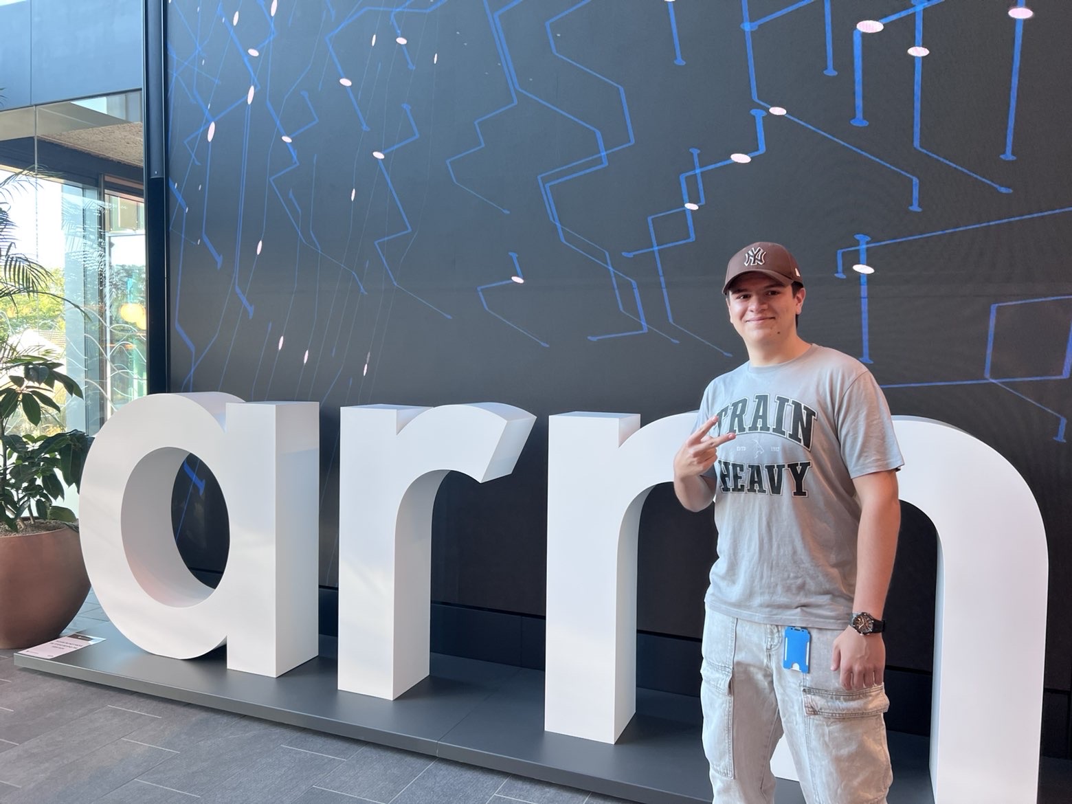 Marko Stefanov standing beside the giant Arm logo