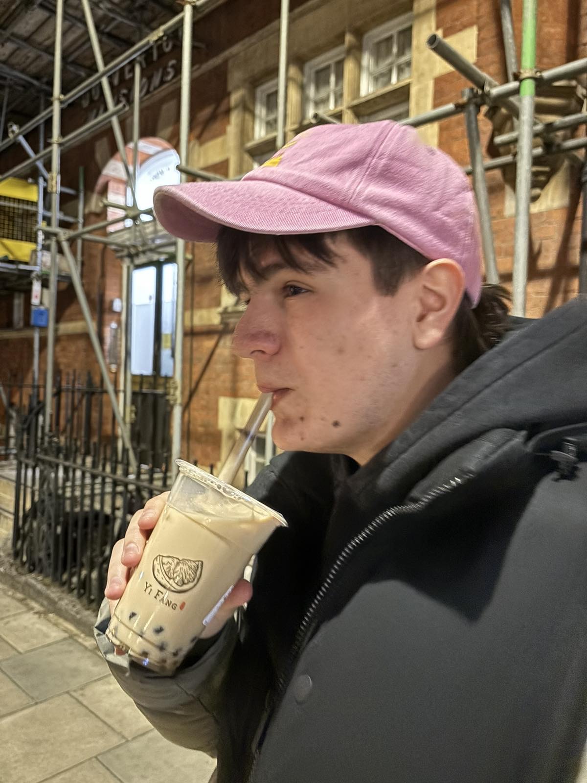 Marko Stefanov in a pink cap, drinking bubble tea